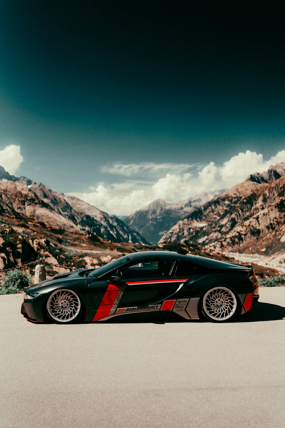 a black sports car parked in the middle of a desert