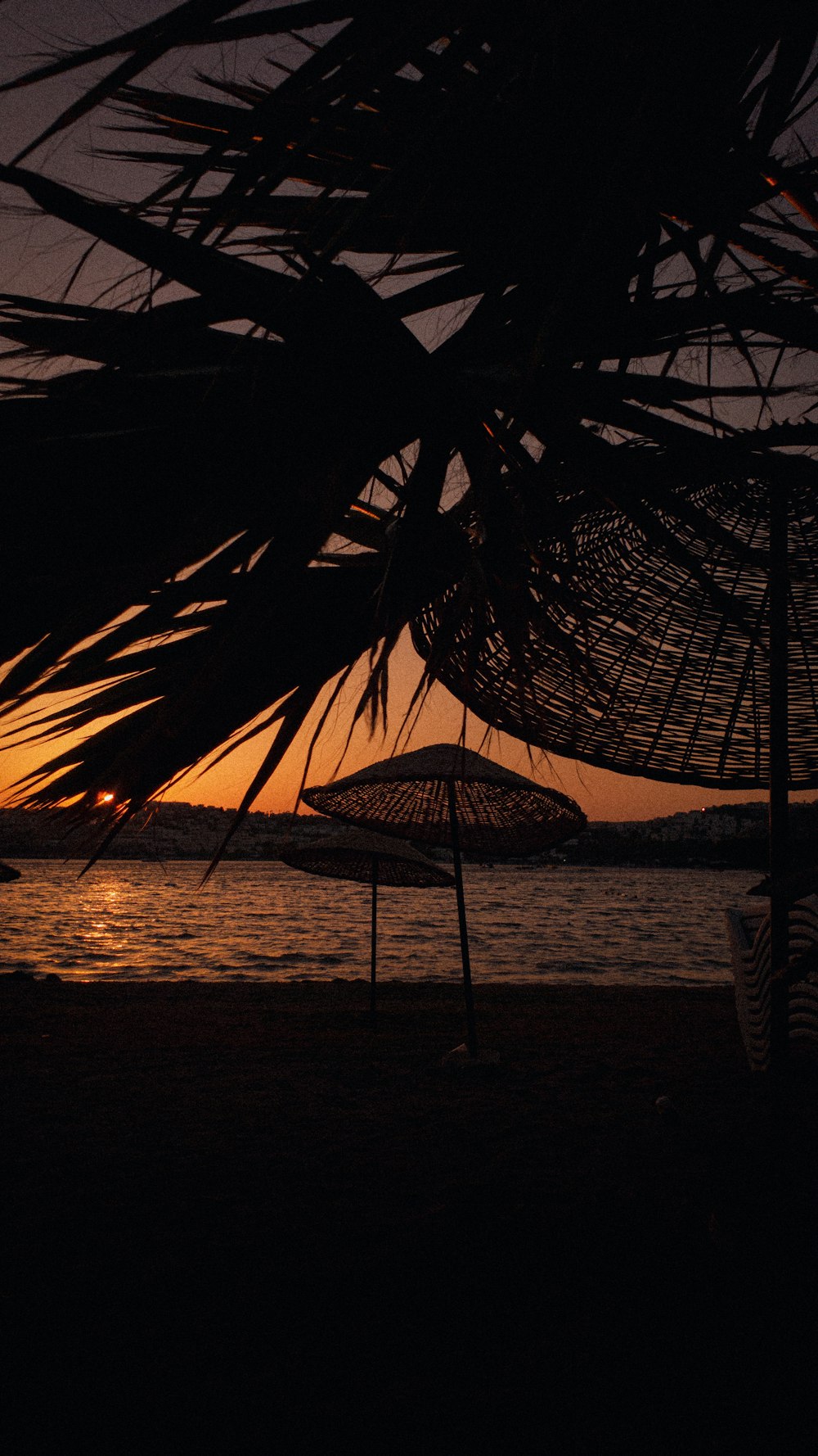 a couple of umbrellas sitting on top of a beach