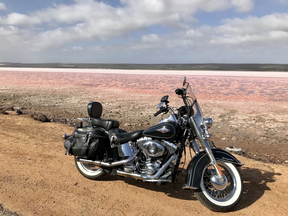 a motorcycle parked on the side of a dirt road