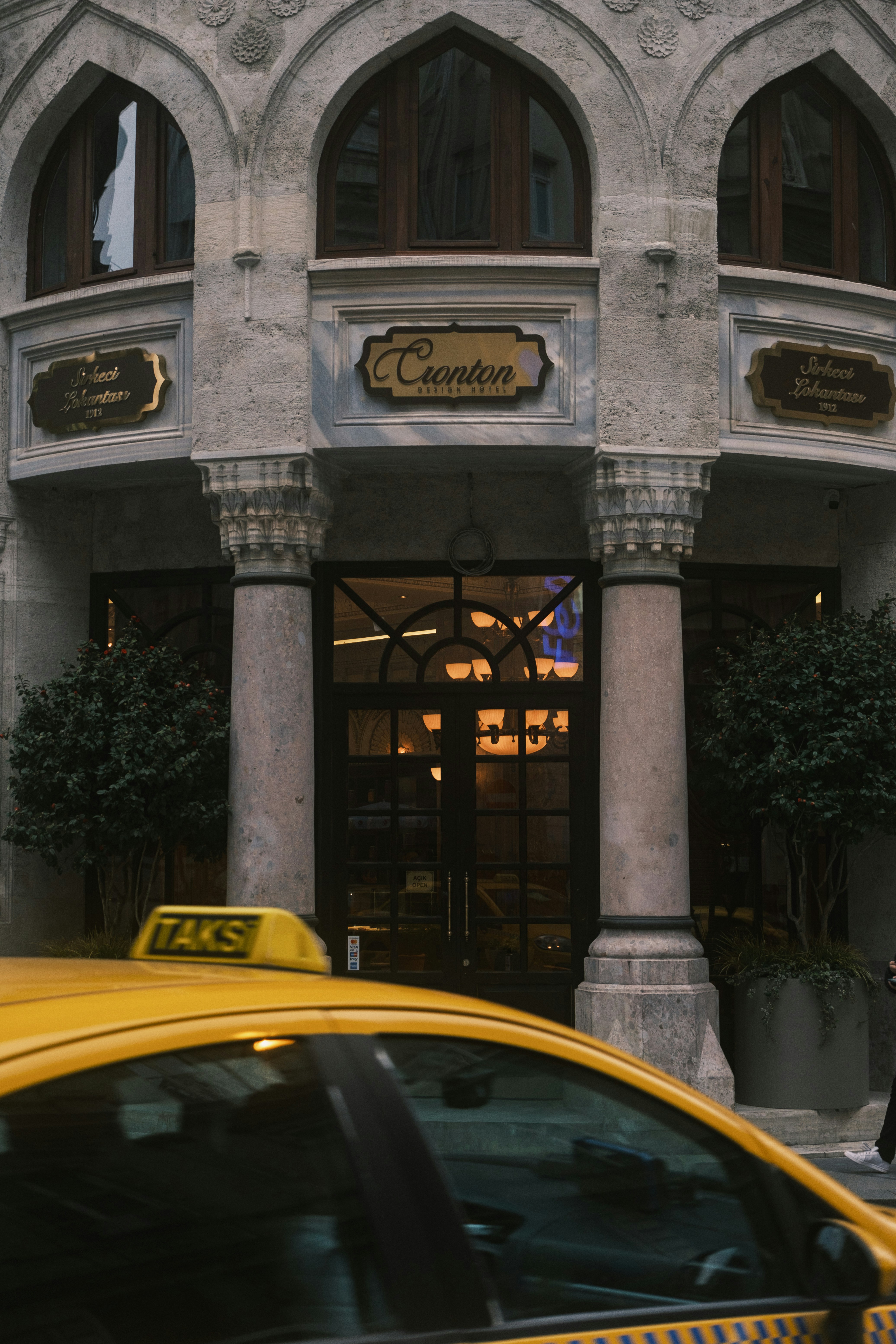 a taxi cab is parked in front of a building