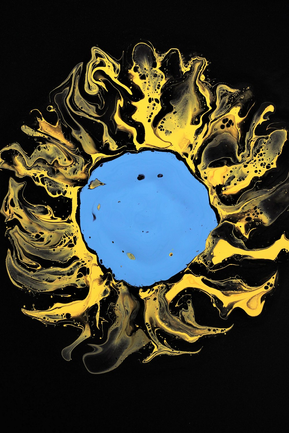 a painting of a sun with a blue center
