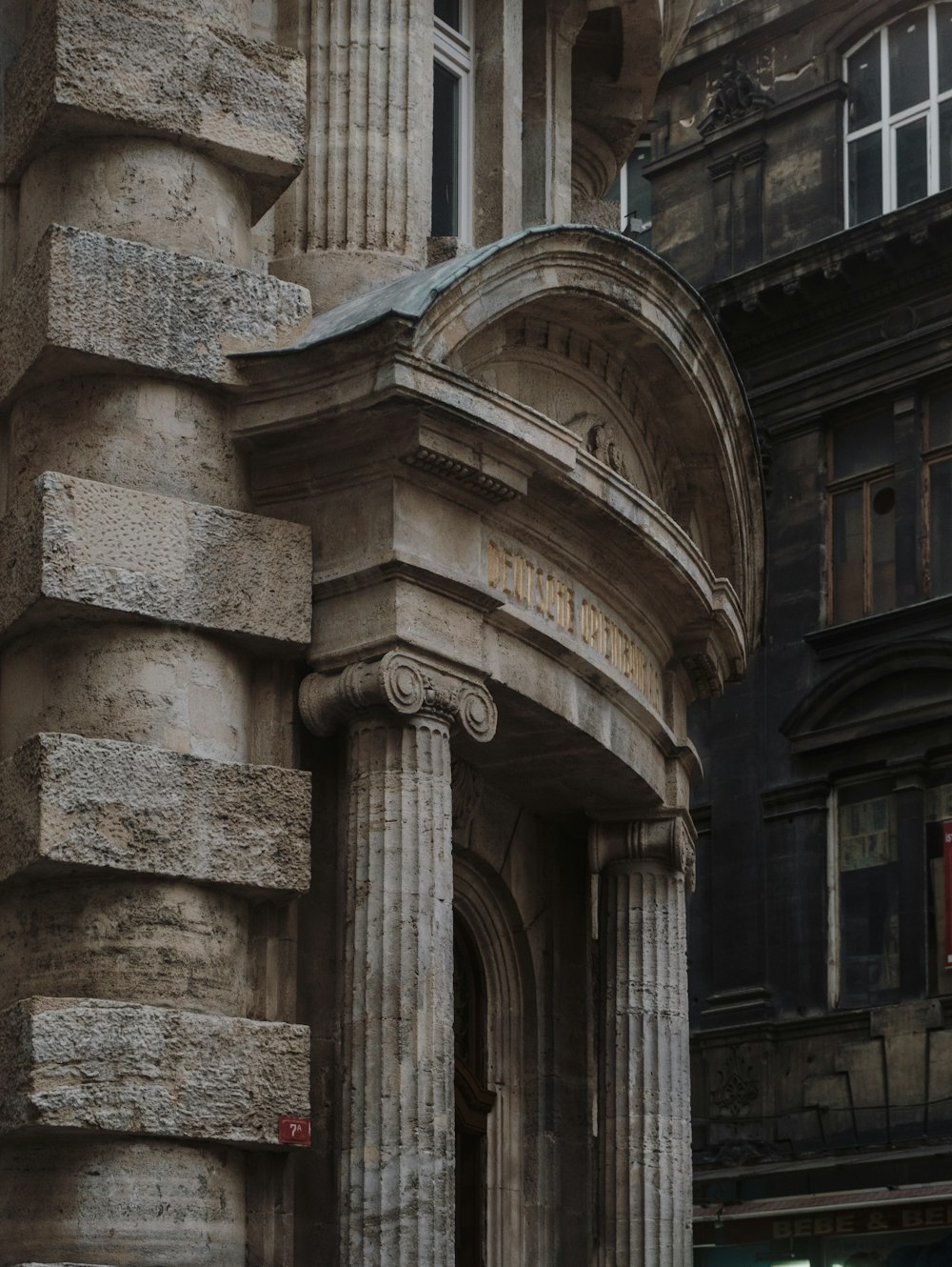 an old building with a clock on the front of it