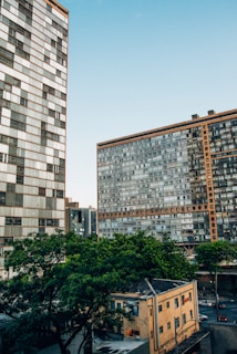 a couple of tall buildings sitting next to each other