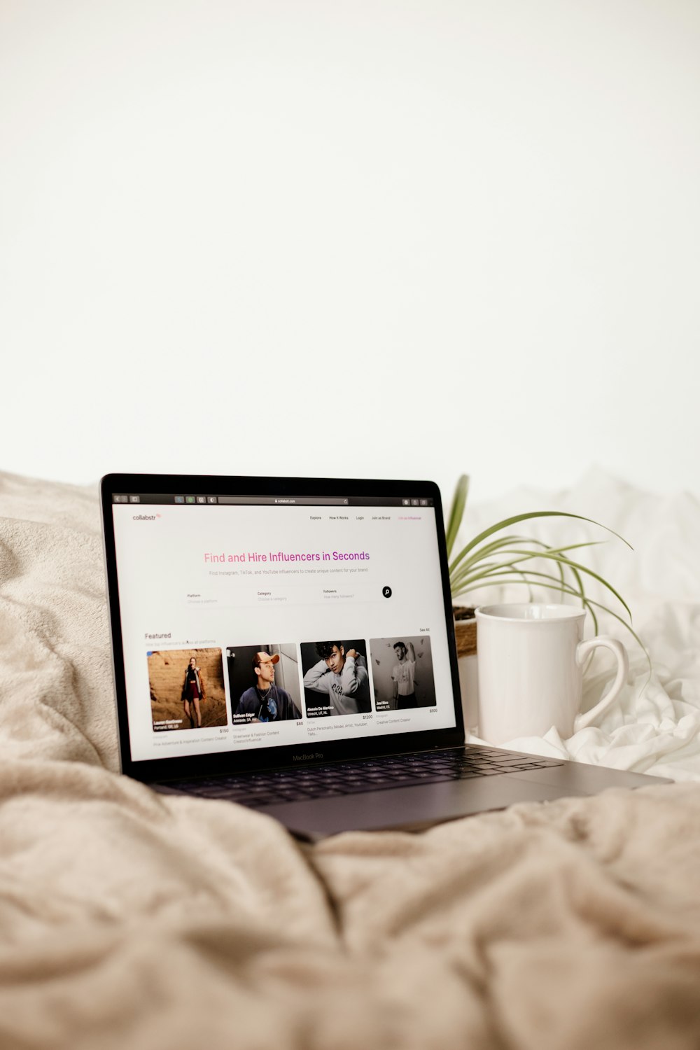 a laptop computer sitting on top of a bed