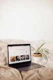a laptop computer sitting on top of a bed