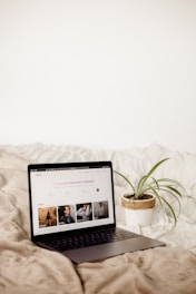 a laptop computer sitting on top of a bed