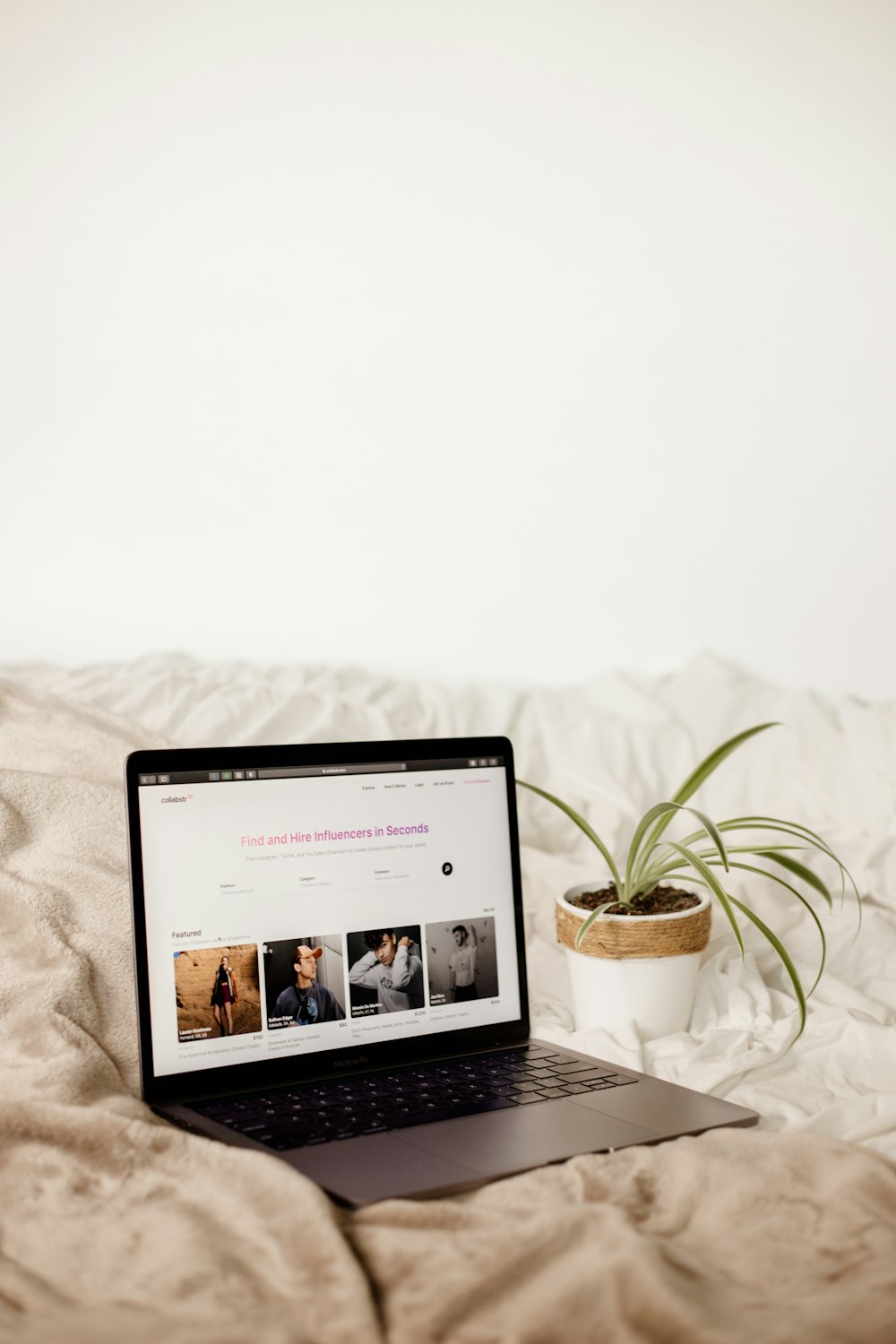 a laptop computer sitting on top of a bed