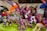 A collection of brightly colored, intricately embroidered stuffed animal toys with various designs including unicorns and llamas. Each toy features vibrant patterns and multicolored threads, creating a festive and artistic display.
