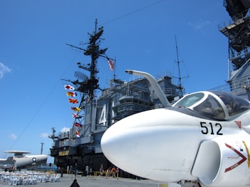 a fighter jet sitting on top of an aircraft carrier