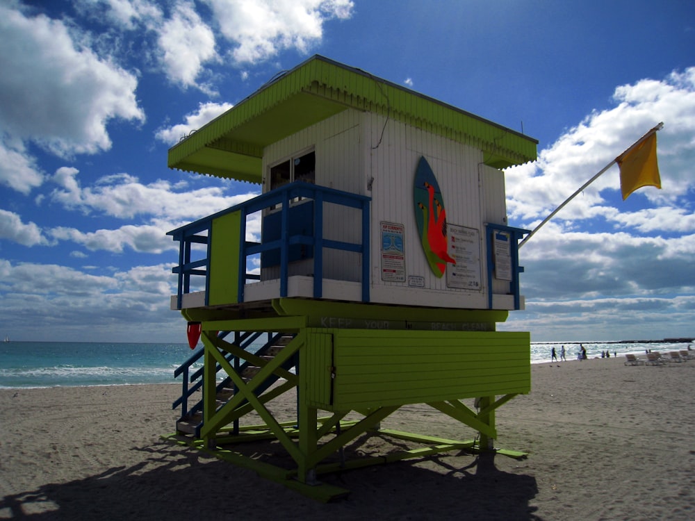 a lifeguard stand on the beach with a flag flying