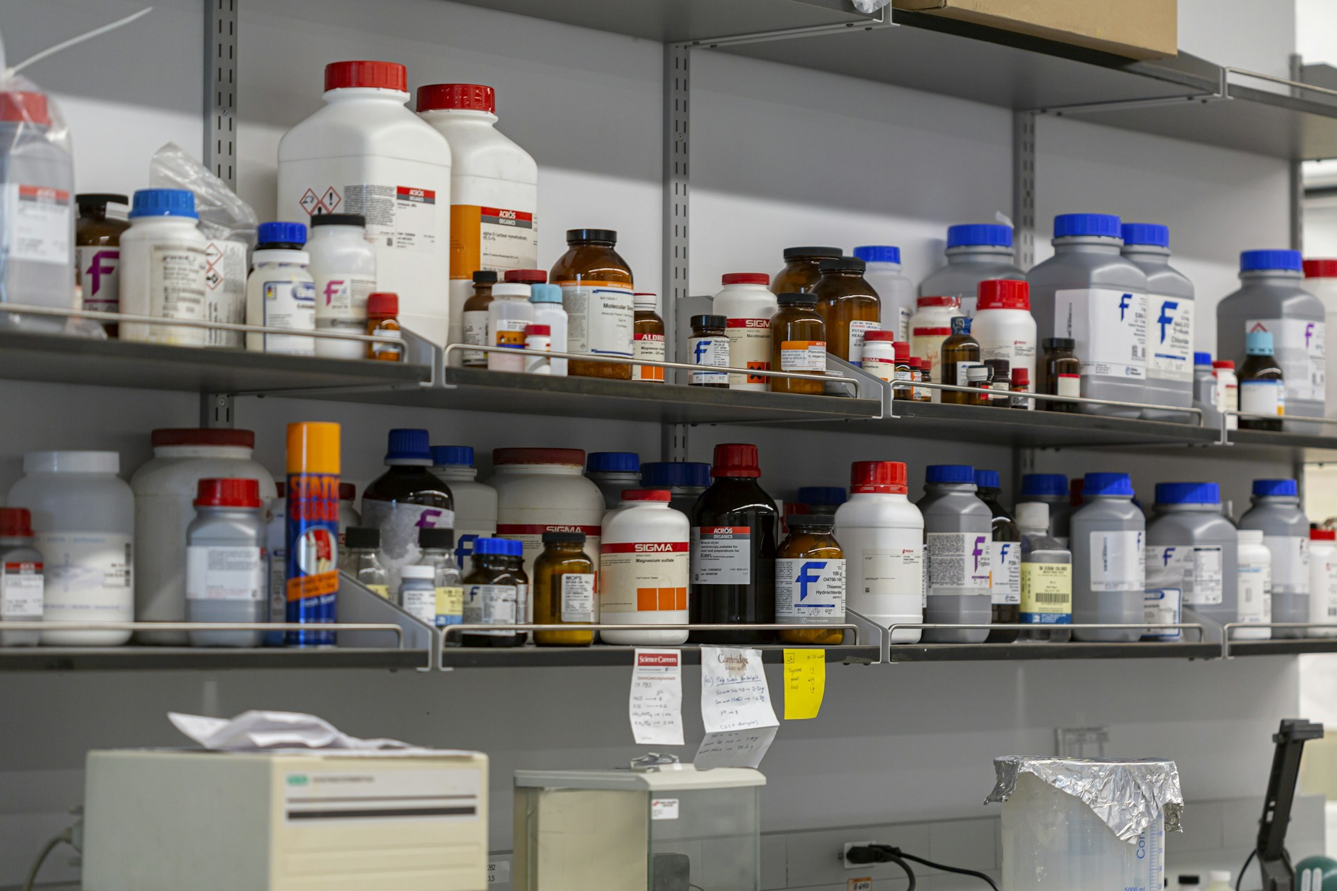 Laboratory shelves filled with chemical bottles.