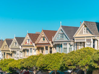 a row of houses with trees in front of them