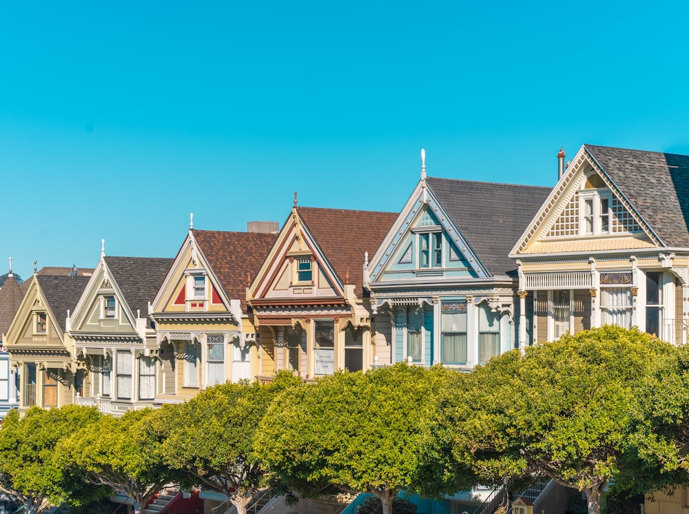 a row of houses with trees in front of them