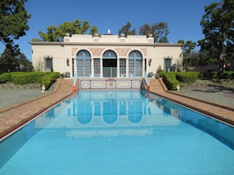 a large swimming pool in front of a house