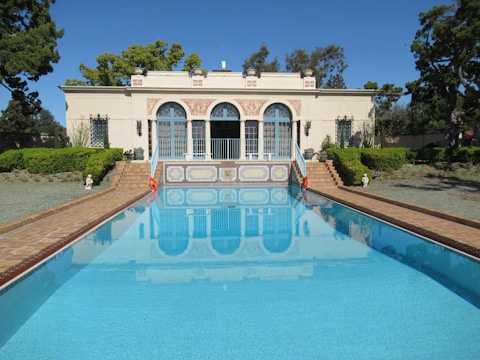 a large swimming pool in front of a house