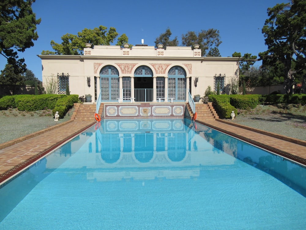 a large swimming pool in front of a house