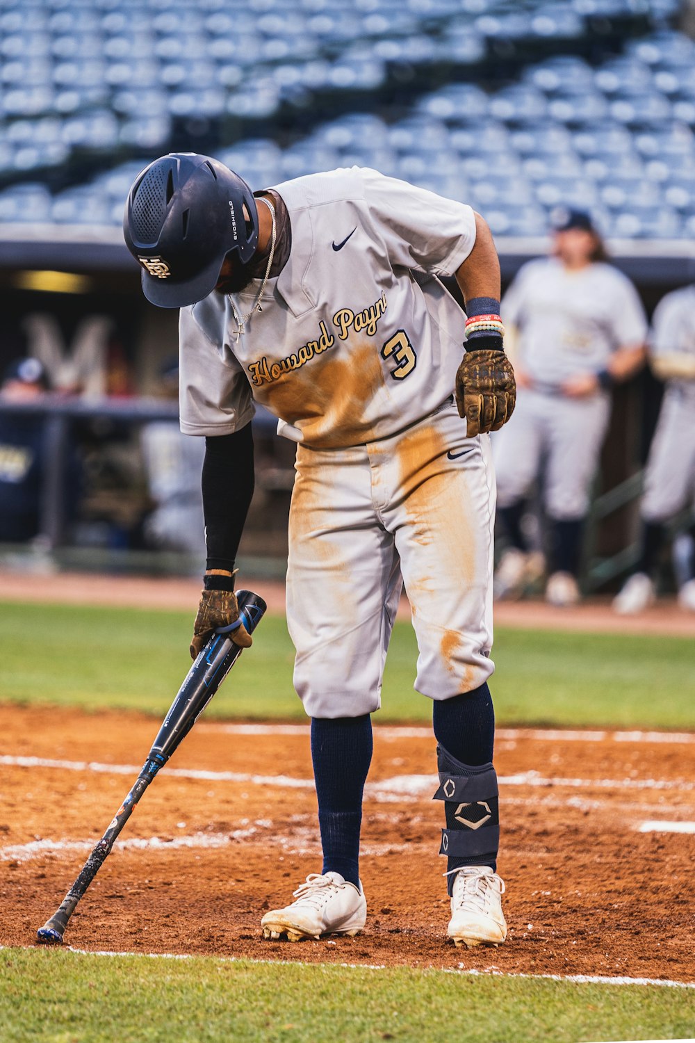 a baseball player holding a bat on a field