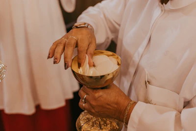 Close-up of hands holding the Eucharist bread in reverence.