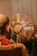a man sitting in front of a golden fan