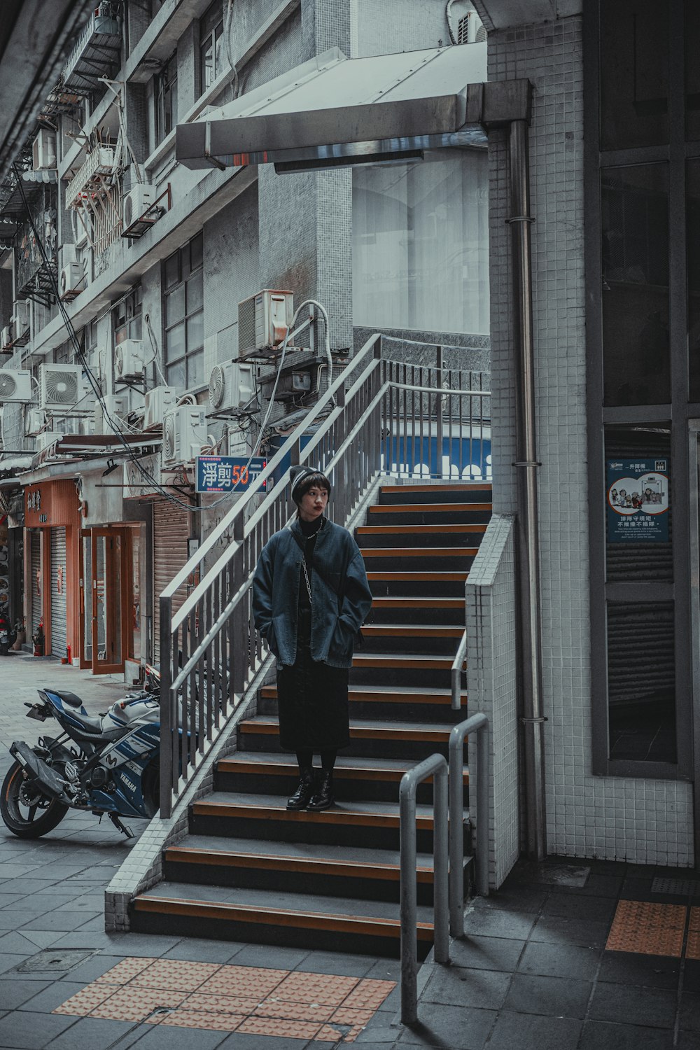 a man standing on a set of stairs in front of a building