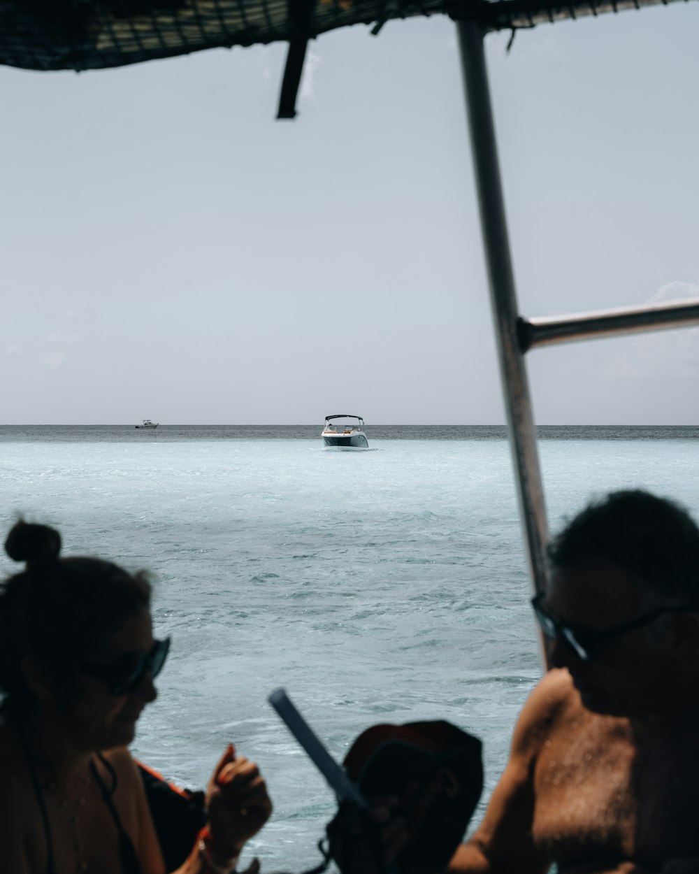 a couple of people sitting on a boat in the water