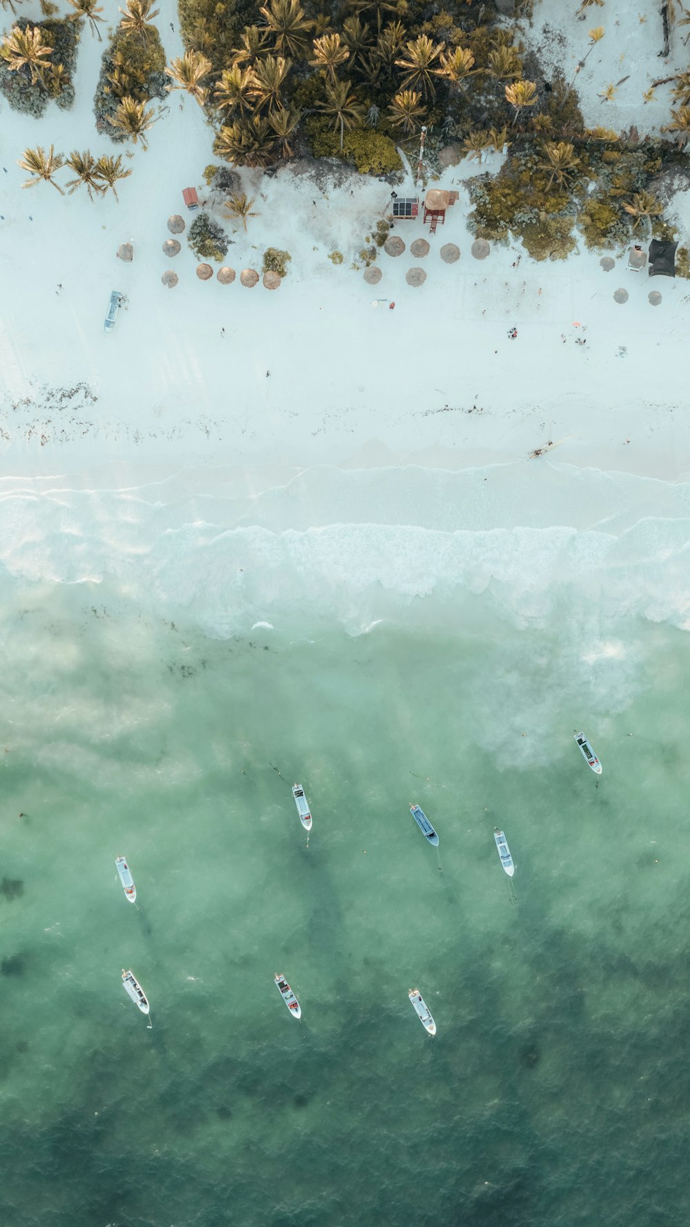 a group of boats floating on top of a body of water