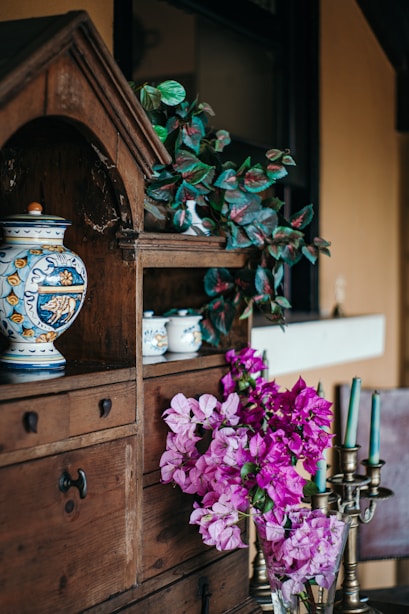 a vase filled with purple flowers sitting on top of a table