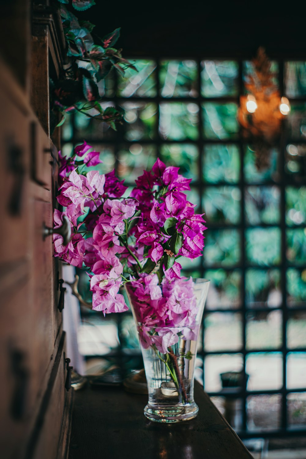 a vase filled with purple flowers sitting on top of a table