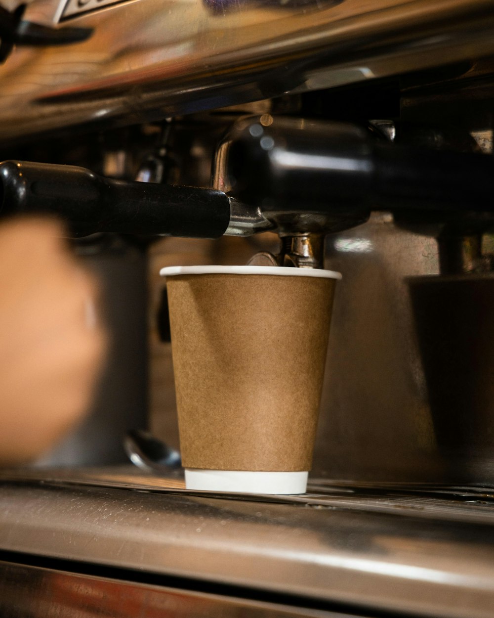 a coffee cup sitting on top of a coffee machine