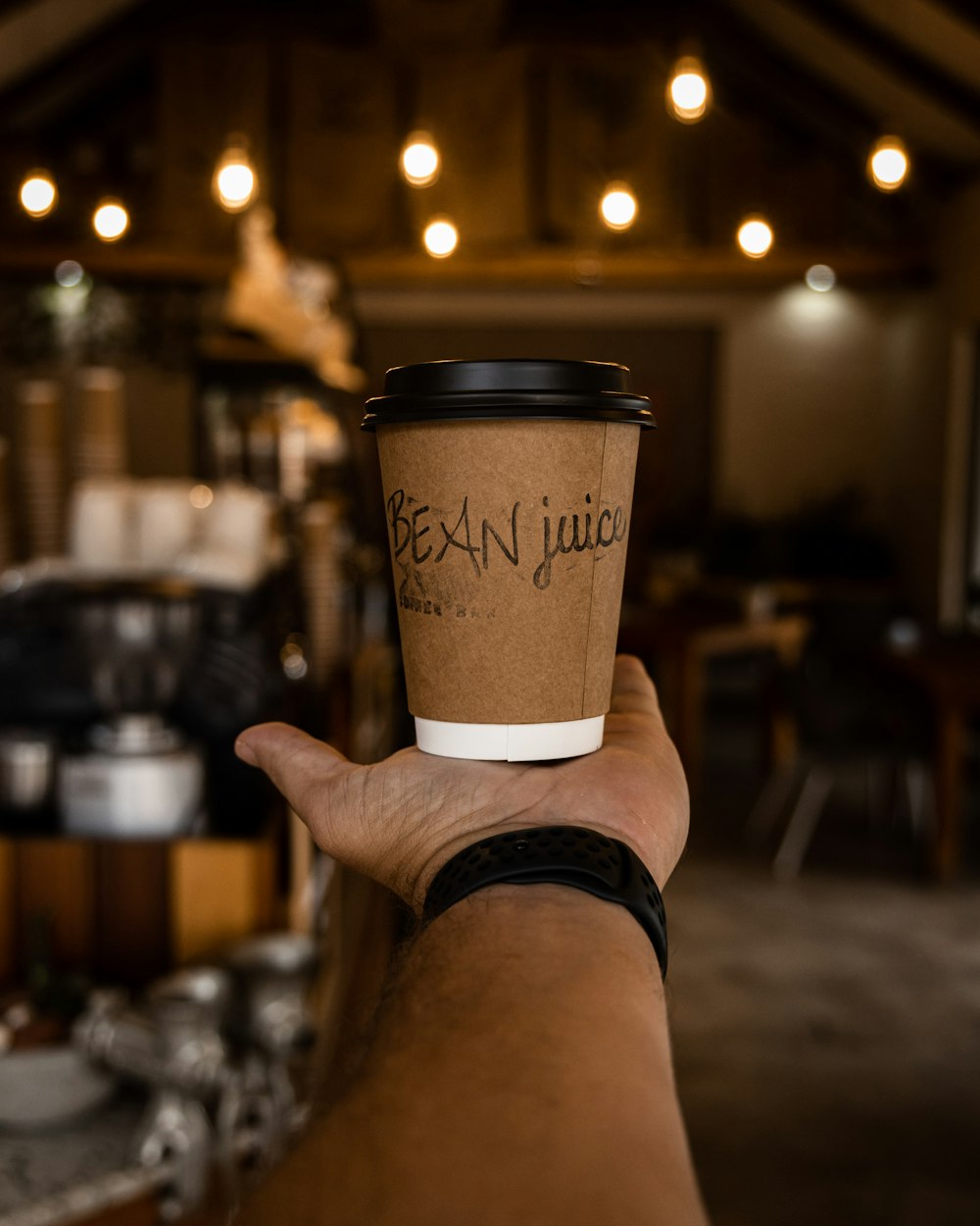 a person holding a cup of coffee in their hand