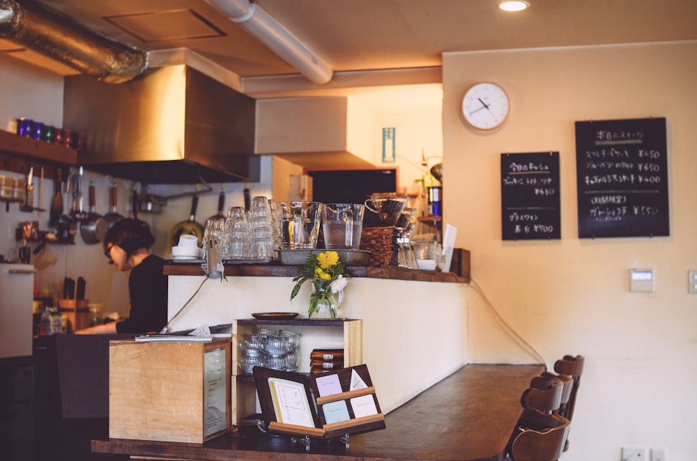 a restaurant with a counter and a clock on the wall