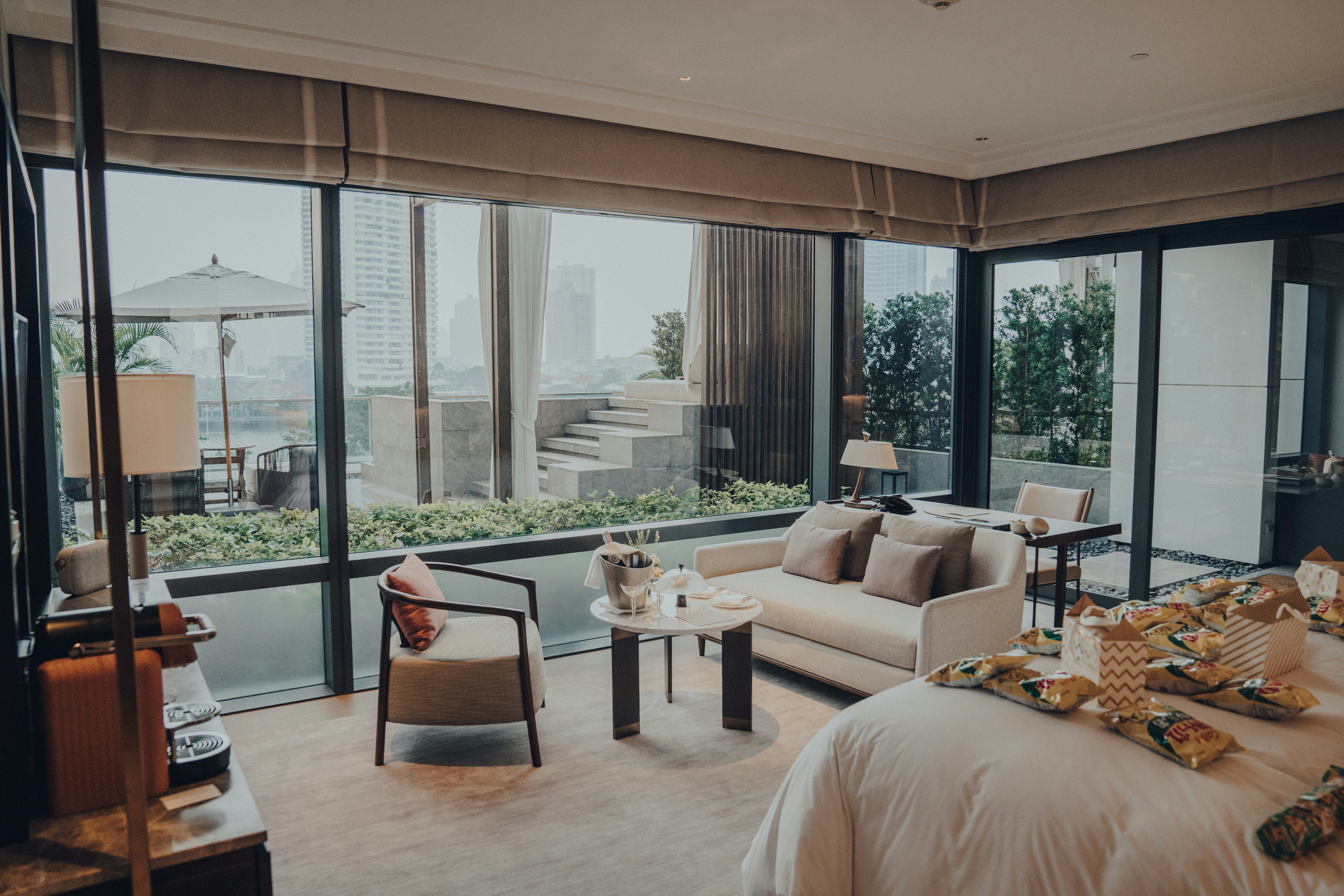 a living area with a couch, chair, table, and windows, 