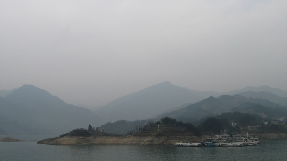 a body of water surrounded by mountains and trees