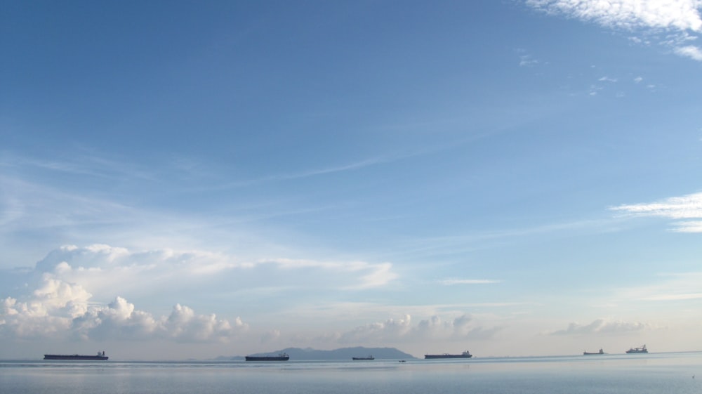 a group of boats floating on top of a large body of water