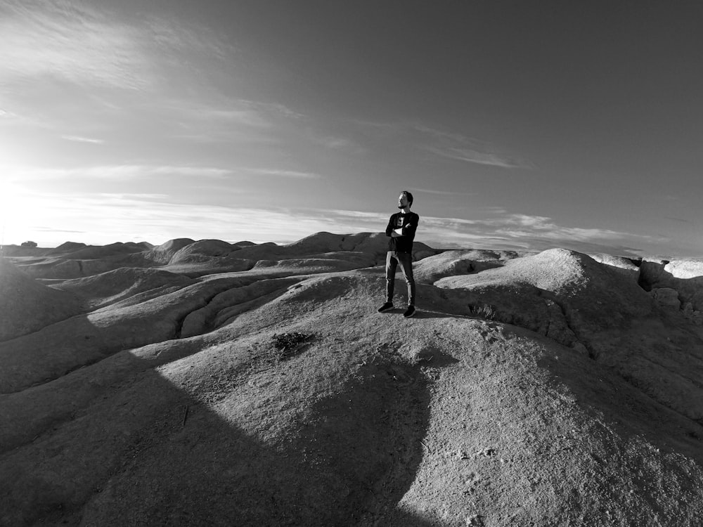 a person standing on top of a large rock