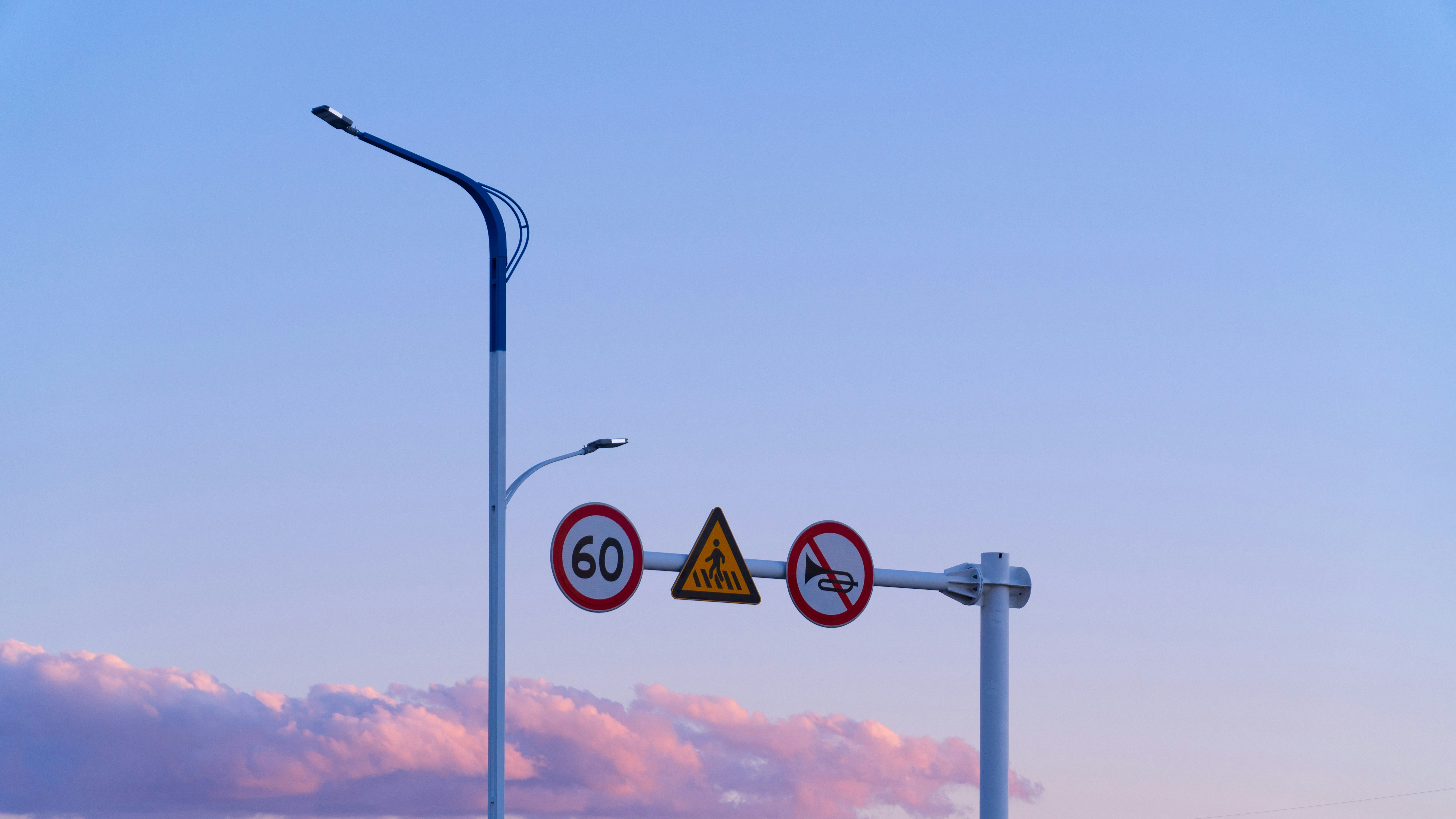 a street light with a sky in the background