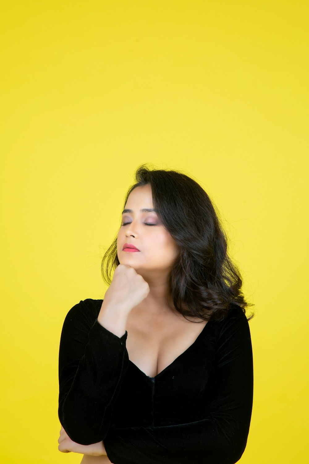 a woman in a black top is posing for a picture