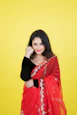 a woman in a red sari posing for a picture
