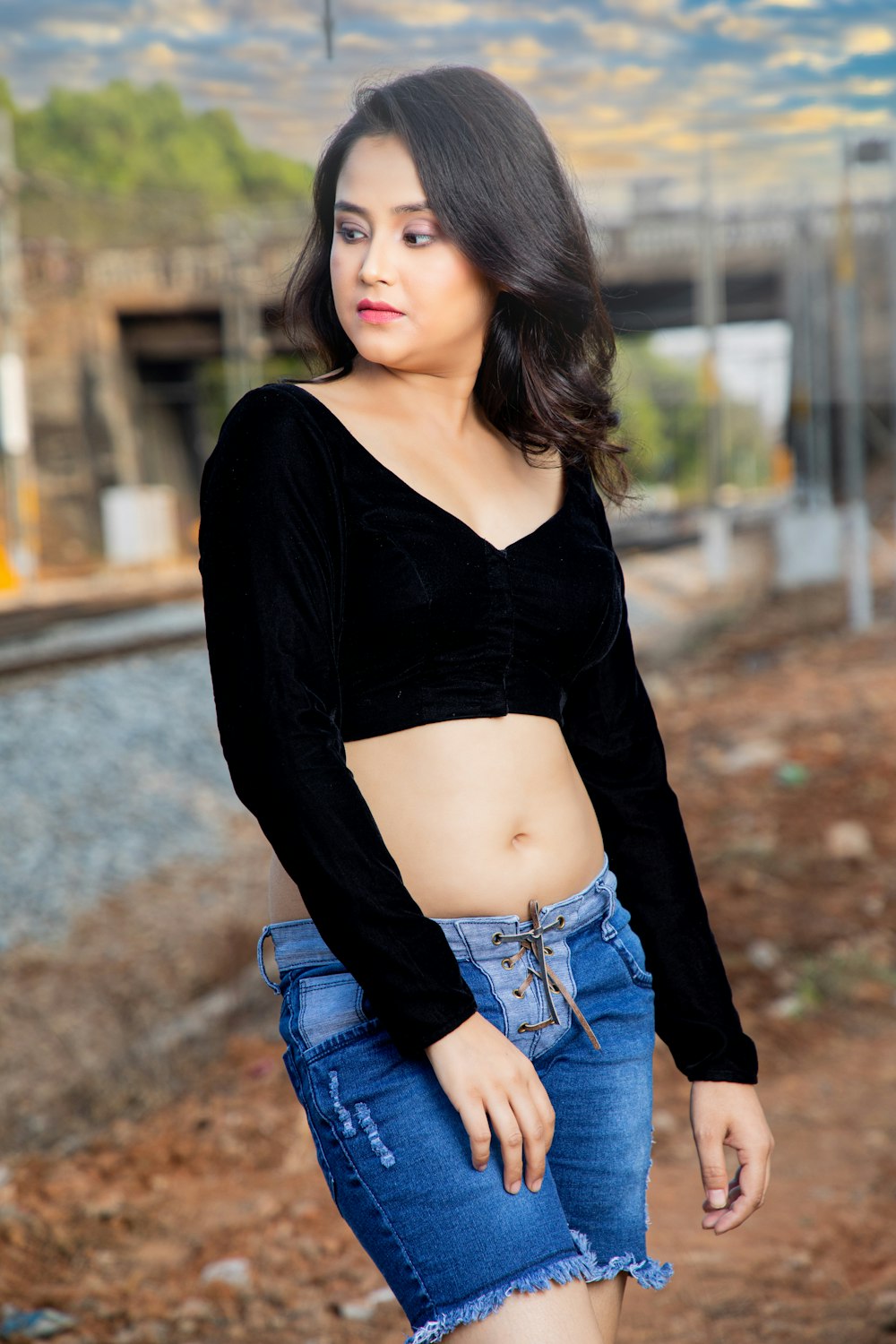 a woman in a black top and jean shorts