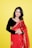 a woman in a red sari posing for a picture