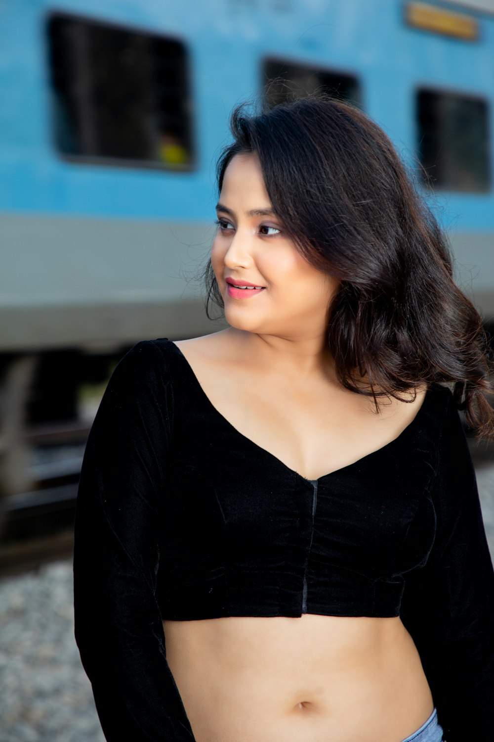 a woman standing in front of a train