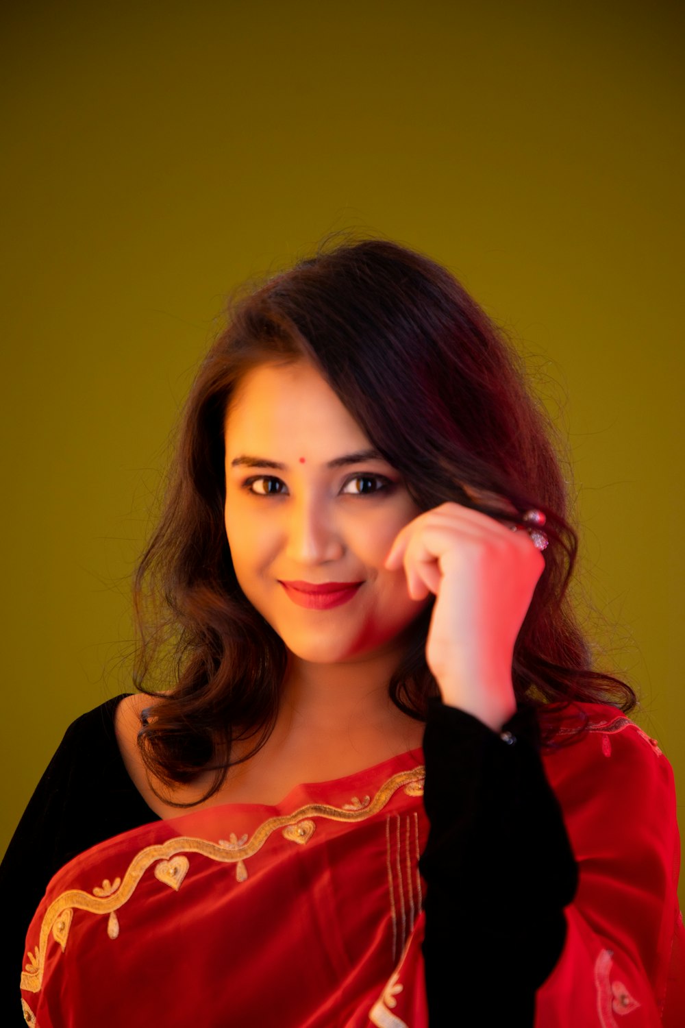 a woman in a red sari posing for a picture