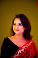 a woman wearing a red shawl and smiling