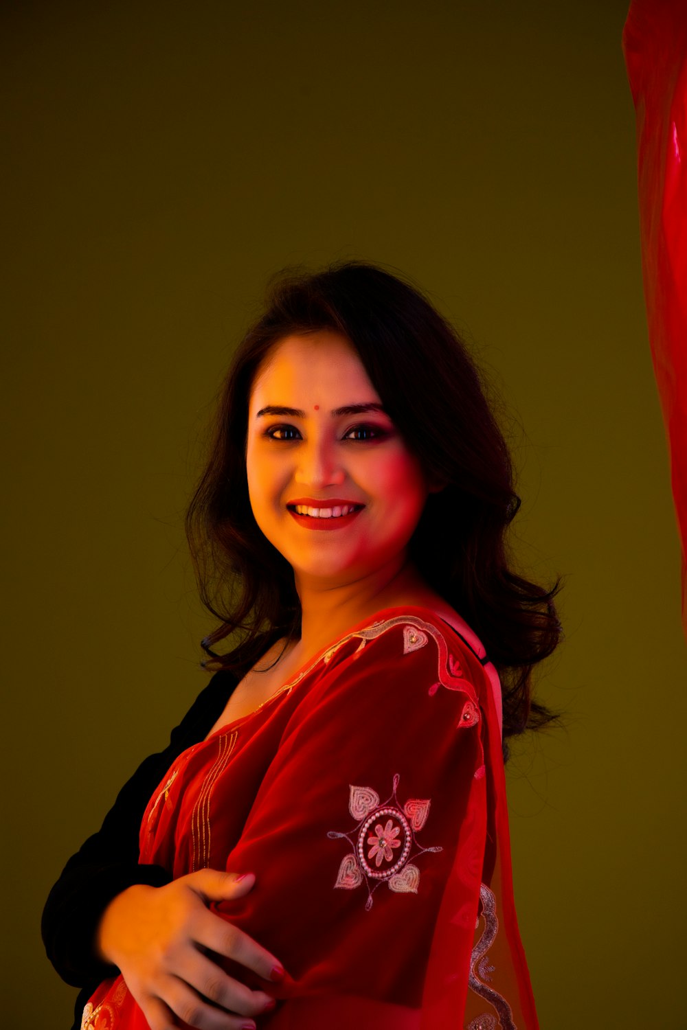 a woman wearing a red scarf and smiling