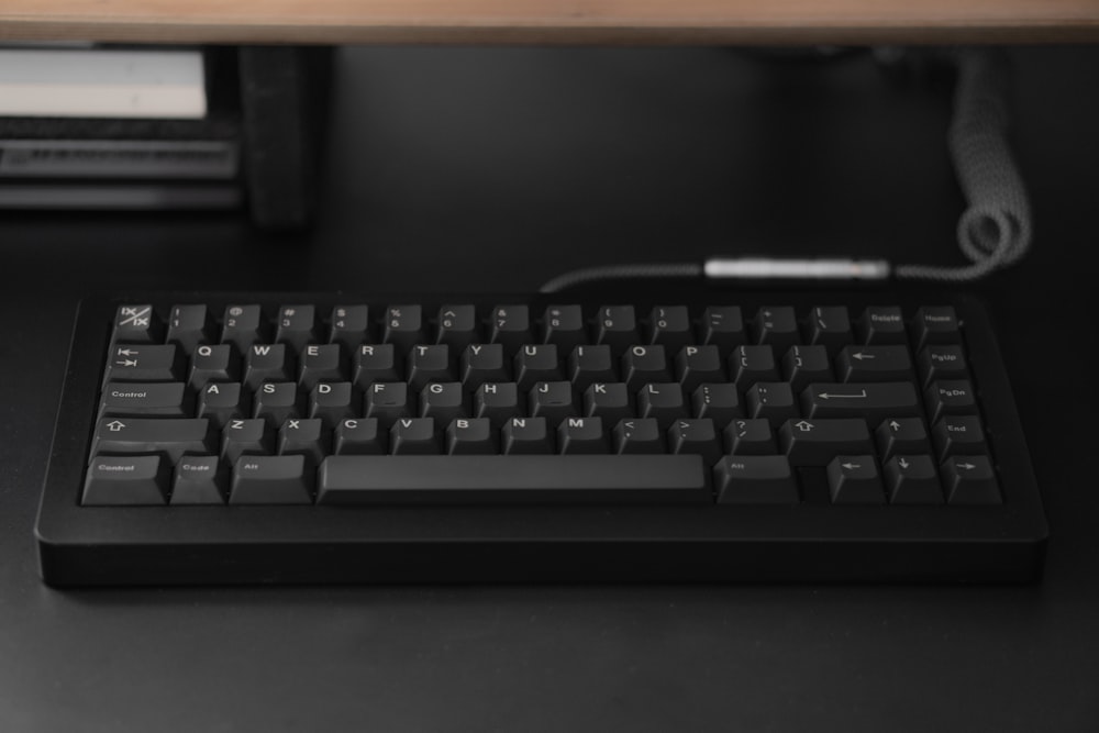 a computer keyboard sitting on top of a desk