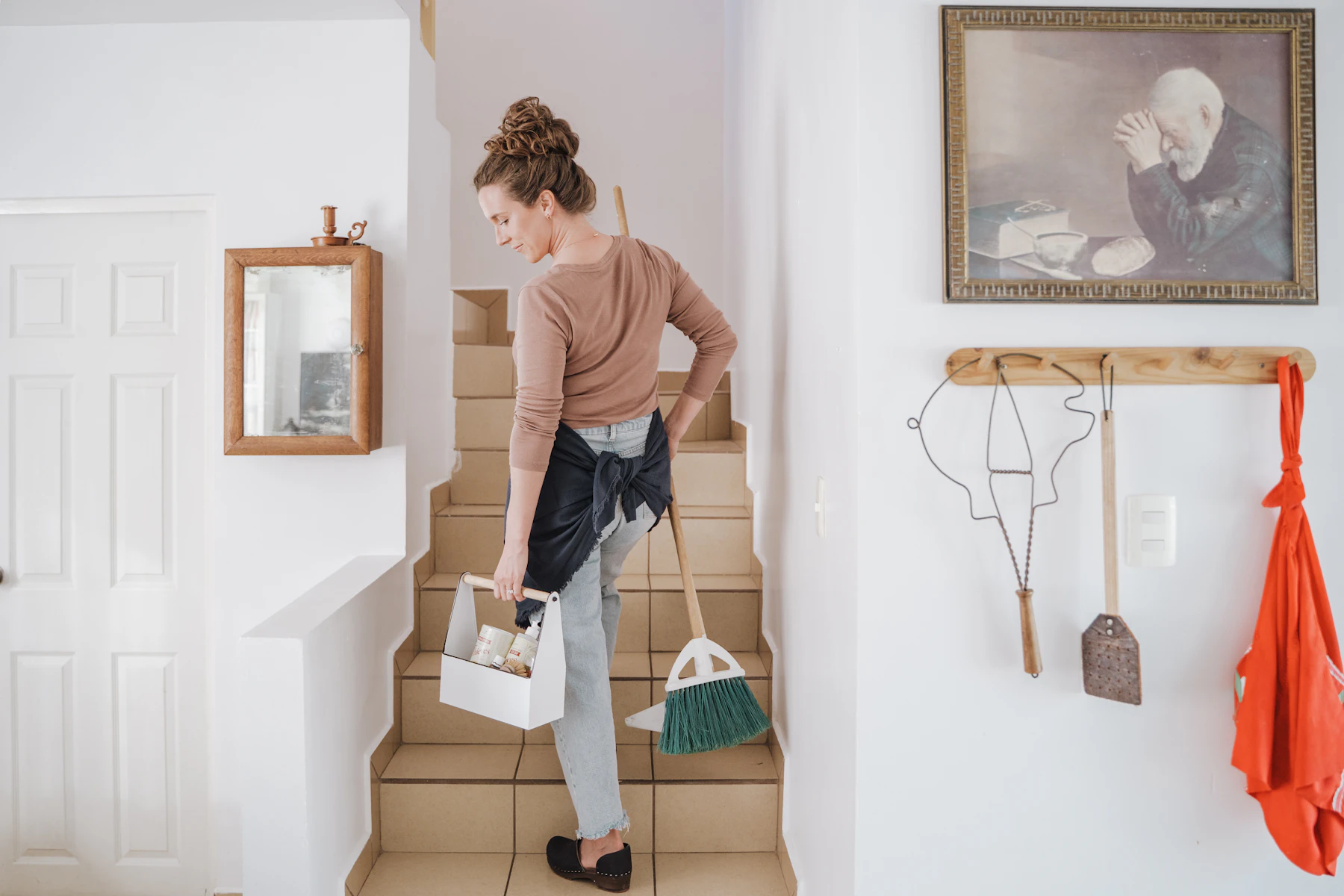 A member of our team dusting and tidying a bright living room