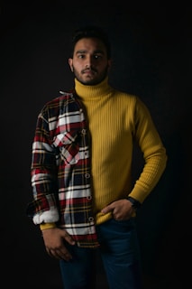 a man in a yellow sweater and plaid jacket