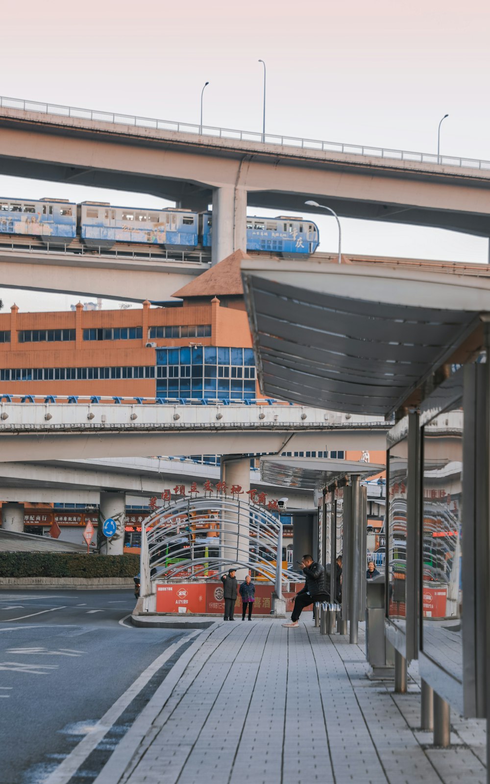 a couple of people walking down a sidewalk next to a train