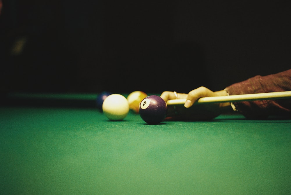 a pool table with pool balls and cues