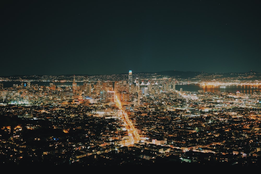 a view of a city at night from the top of a hill